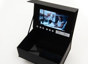 video box with open lid and screen showing a movie